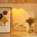 Decorative setup with jars and a vase on a shelf against a wall with abstract art.