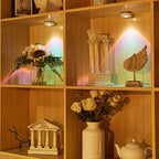 Wooden shelf with decorative items including flowers, statues, and a teapot.