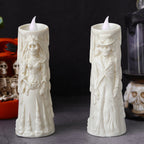 Two skeleton-themed candles on a dark background