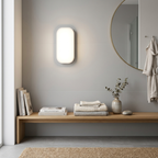 Modern bathroom interior with a wooden shelf, light fixture, and round mirror.