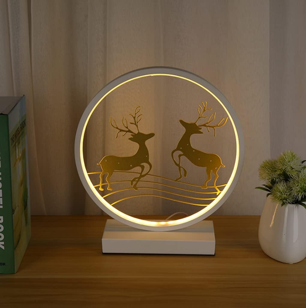 Decorative lamp with deer design on a wooden surface