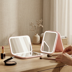 Two portable LED mirrors on a wooden surface with makeup items.