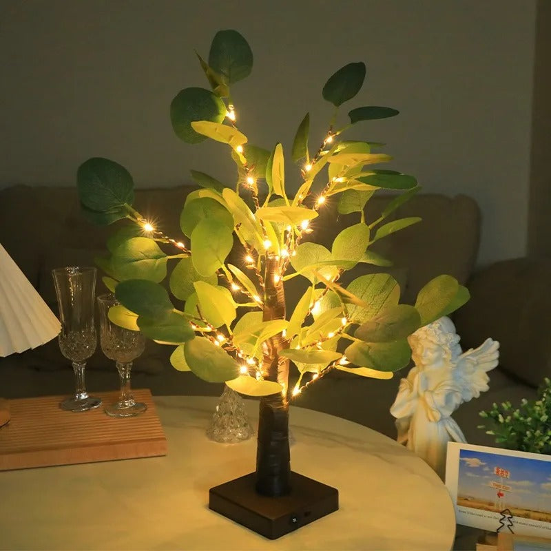 Decorative LED tree on a table with a blurred background