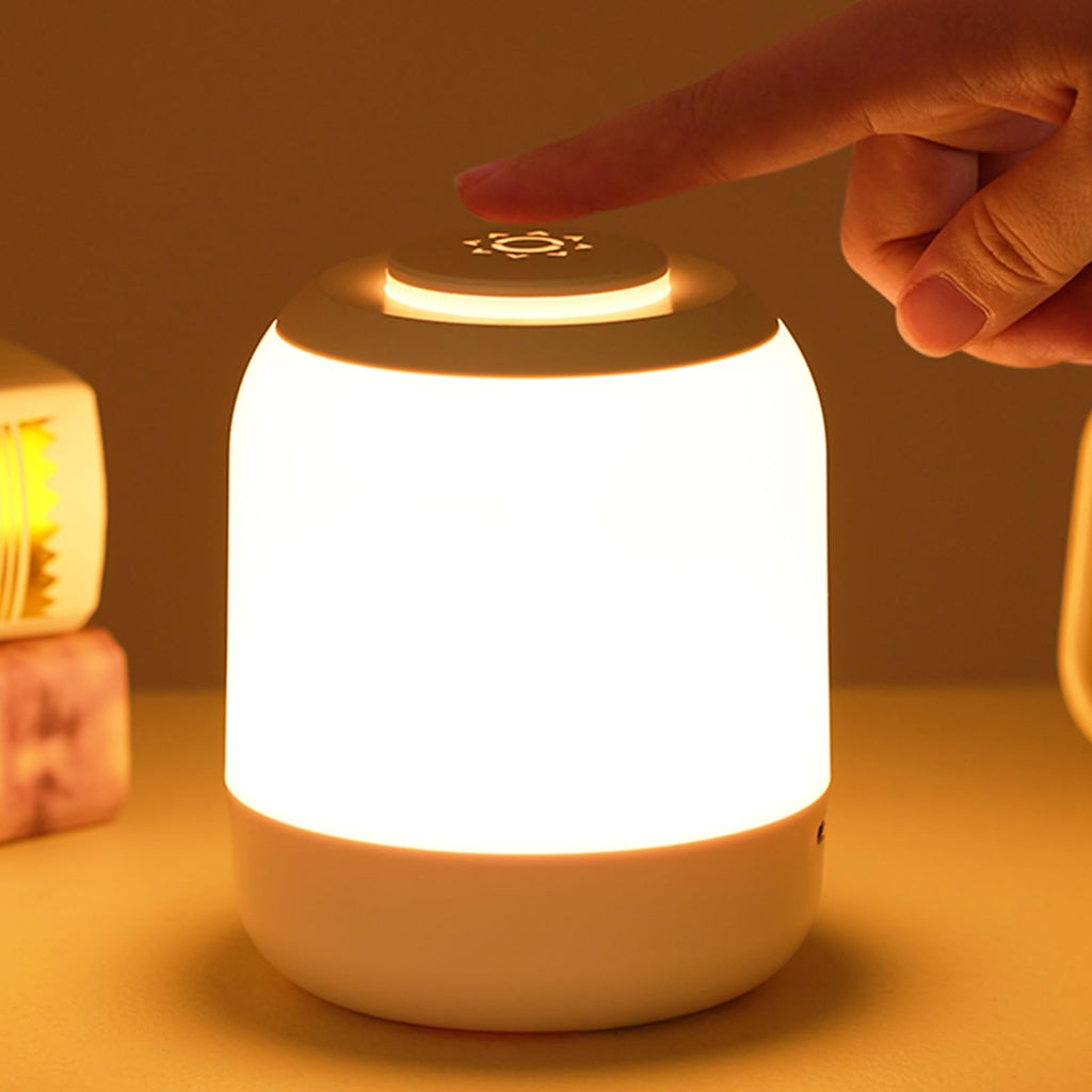 Hand pressing a button on a glowing night light with a warm glow.