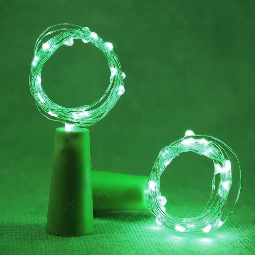 Green LED fairy string lights coiled in two circular loops, one resting on a green cone stand and the other on a matching green surface, against a solid green background.