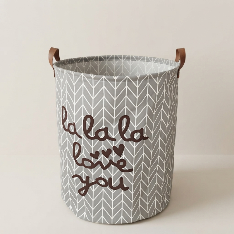 Storage basket with gray chevron pattern and brown text on a beige background