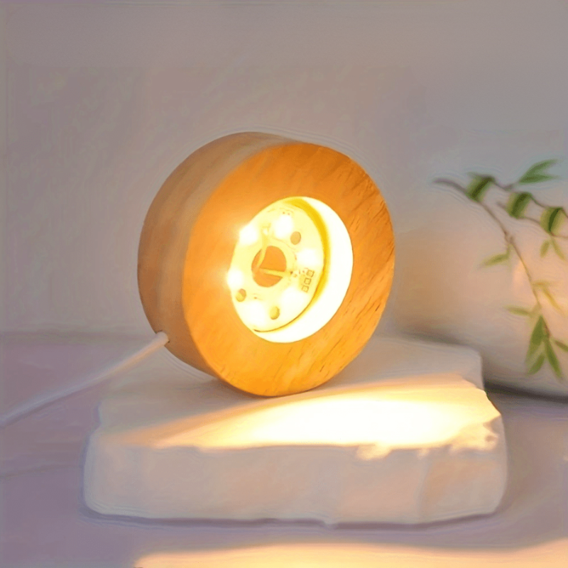 Wooden lamp with glowing interior on a white surface