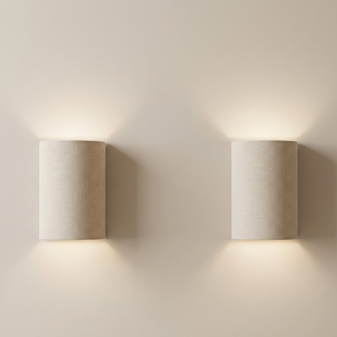 Two cylindrical wall lights on a plain wall
