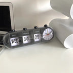 Desk with a clock displaying the time, date, and day of the week.