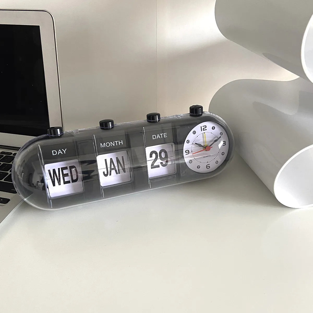 Desk with a clock displaying the time, date, and day of the week.