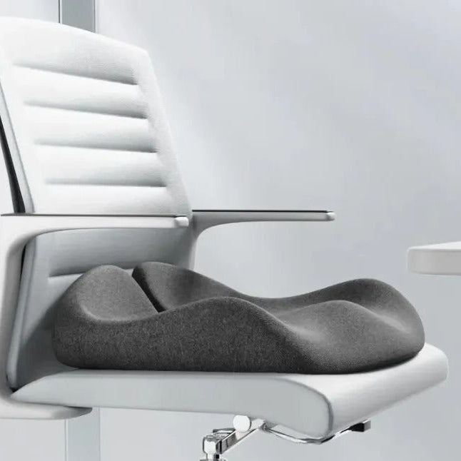 Gray seat cushion on a white office chair with a plain background