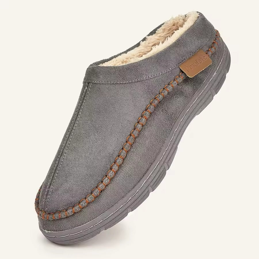 Gray slipper with brown stitching on a white background