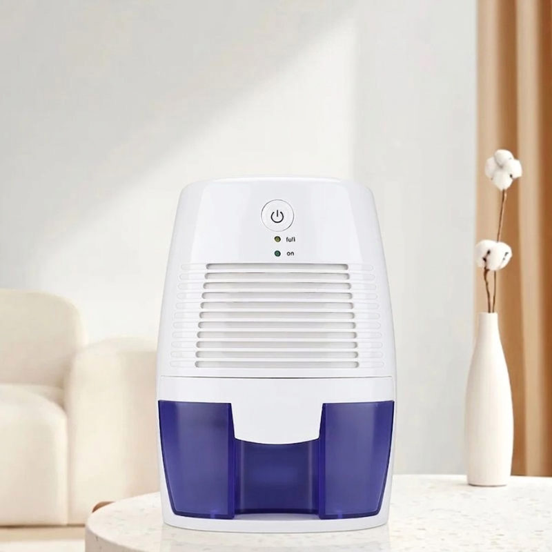 White and blue dehumidifier on a white surface with a neutral background