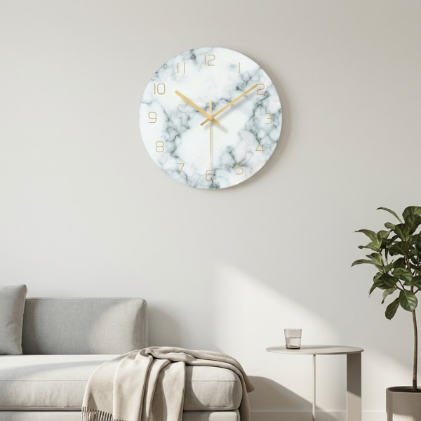 Marble-patterned wall clock on a white wall with a sofa and plant in the background