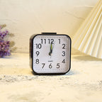 Square alarm clock on a marble surface with a soft background