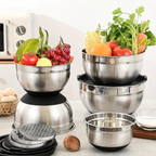 Set of stainless steel bowls with vegetables on a kitchen counter