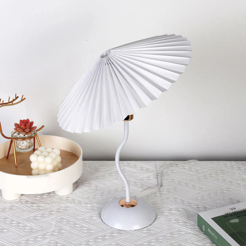 White desk lamp with a unique design on a textured surface.