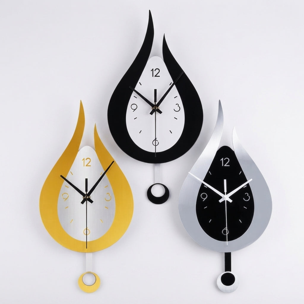 Three flame-shaped wall clocks in black, gold, and silver, arranged symmetrically against a plain white background.