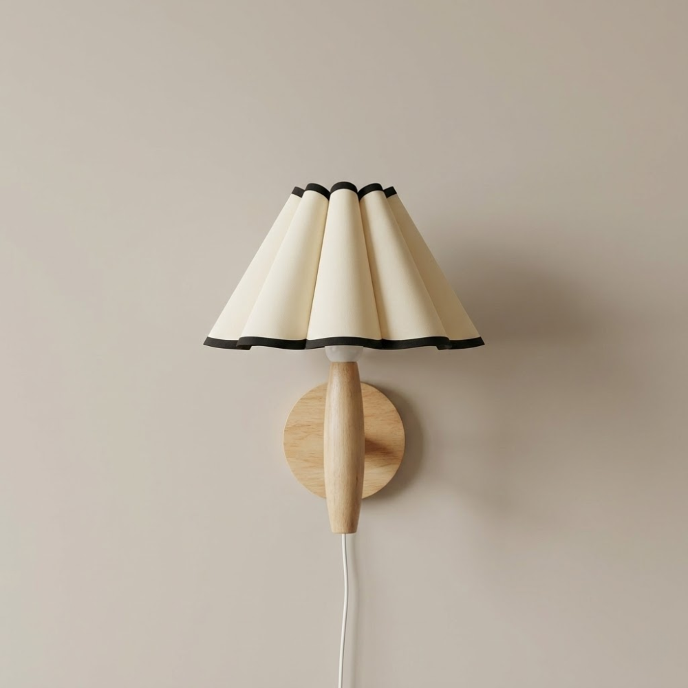 Wall-mounted lamp with a beige lampshade and wooden base on a beige wall.