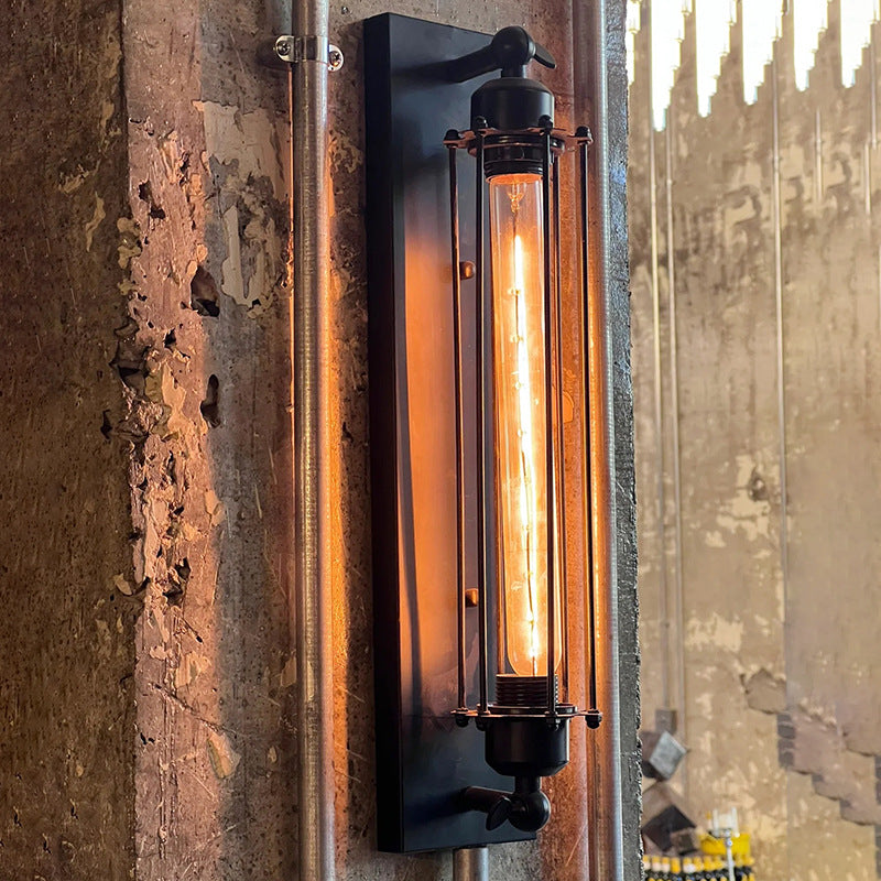 Industrial-style wall-mounted light fixture on a textured wall.
