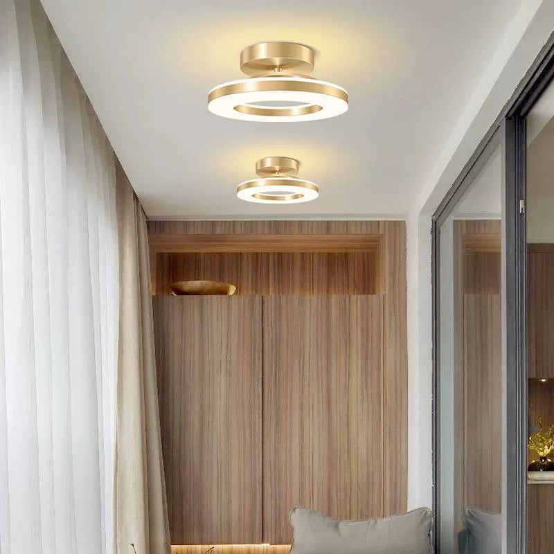 Modern ceiling lights in a room with curtains and a mirror.