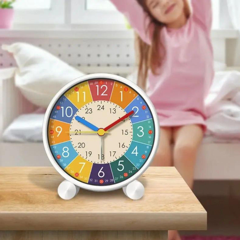 Colorful clock on a wooden table with a child in pink pajamas in the background.