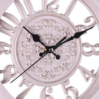 Decorative wall clock with intricate designs and black hands on a white background