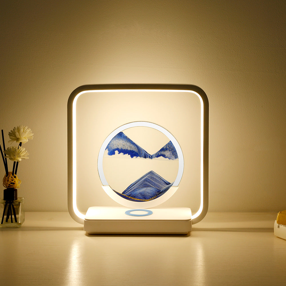 Decorative lamp with mountain design on a table against a beige wall