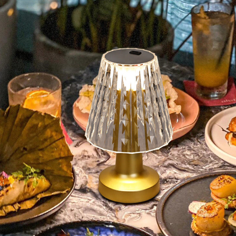 Decorative lamp on a table with food and drinks