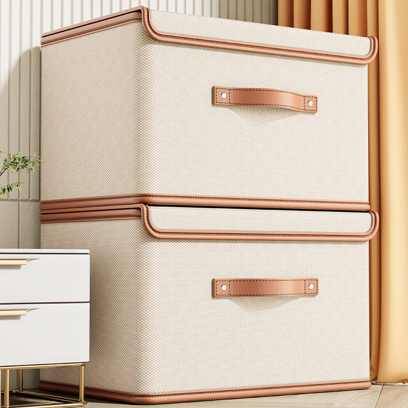 Beige storage box with brown handles on a neutral background