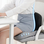 Woman using an ergonomic back support device while sitting at a desk.