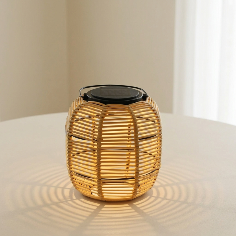 Wicker lantern with black top on a white surface