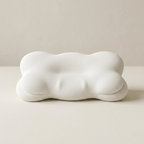 White cloud-shaped pillow on a beige background