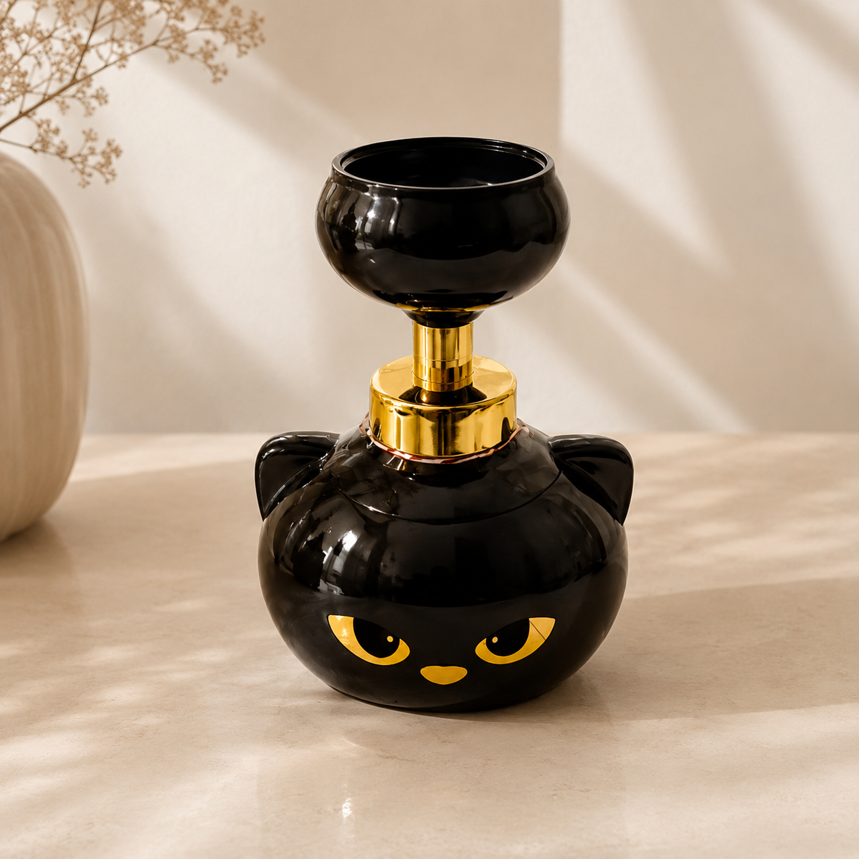 Black cat-shaped bottle with gold accents on a beige surface