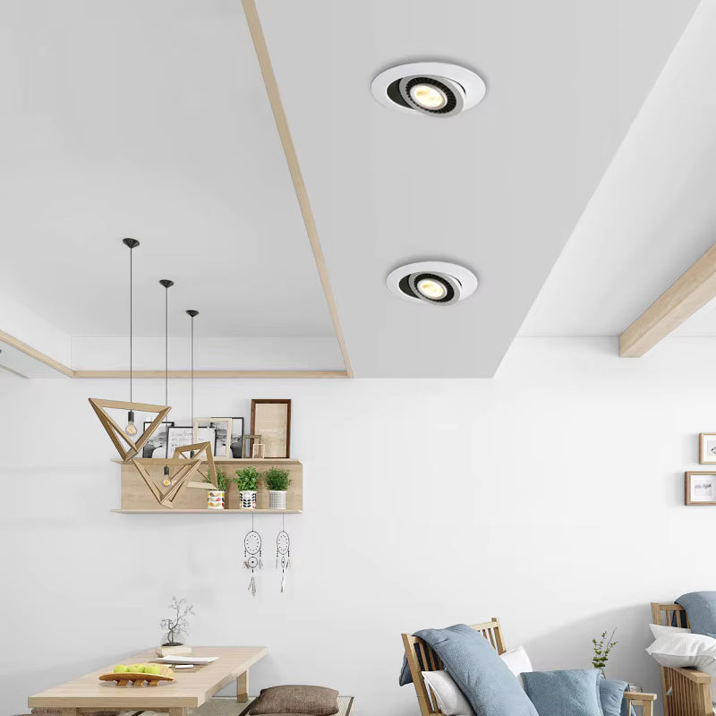 Modern living room with recessed ceiling lights and minimal decor.