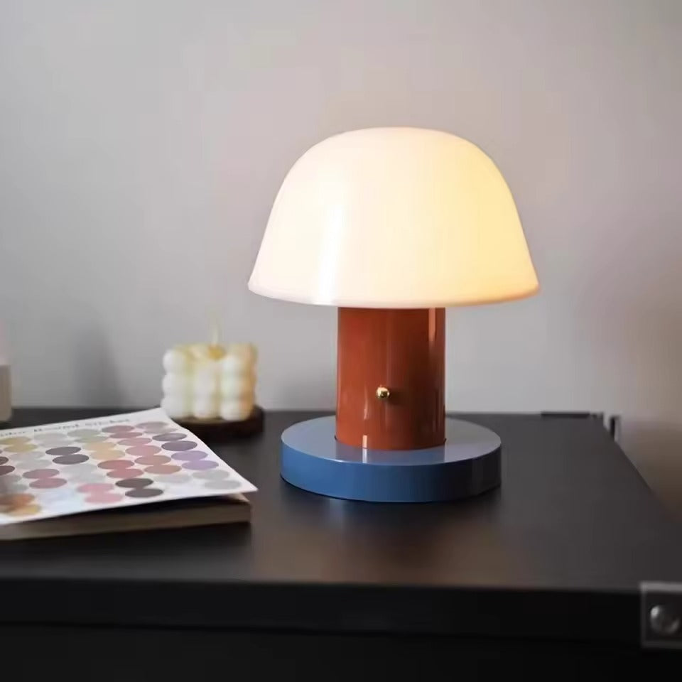 Colorful table lamp on a dark surface with a neutral background