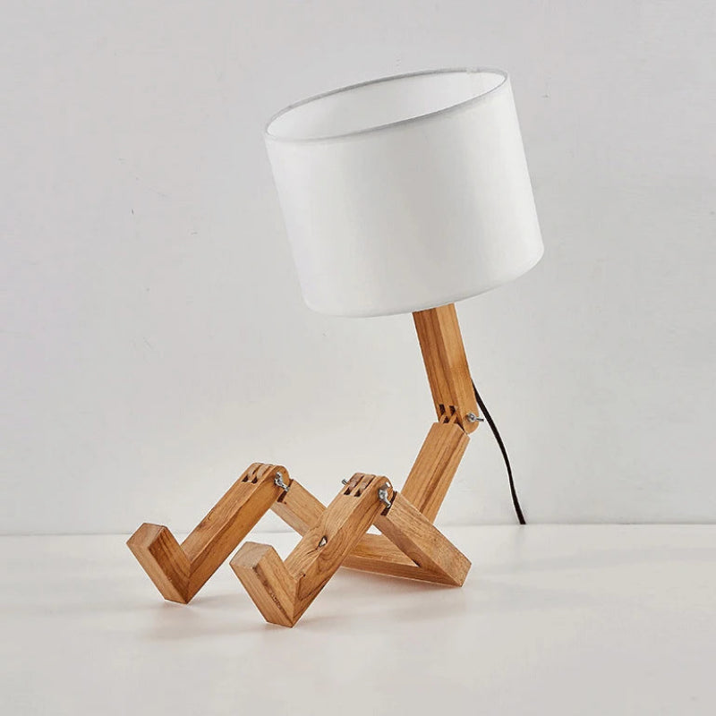 Table lamp with wooden base and white shade on a light gray background