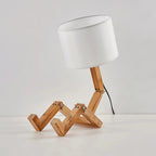 Table lamp with wooden base and white shade on a light gray background