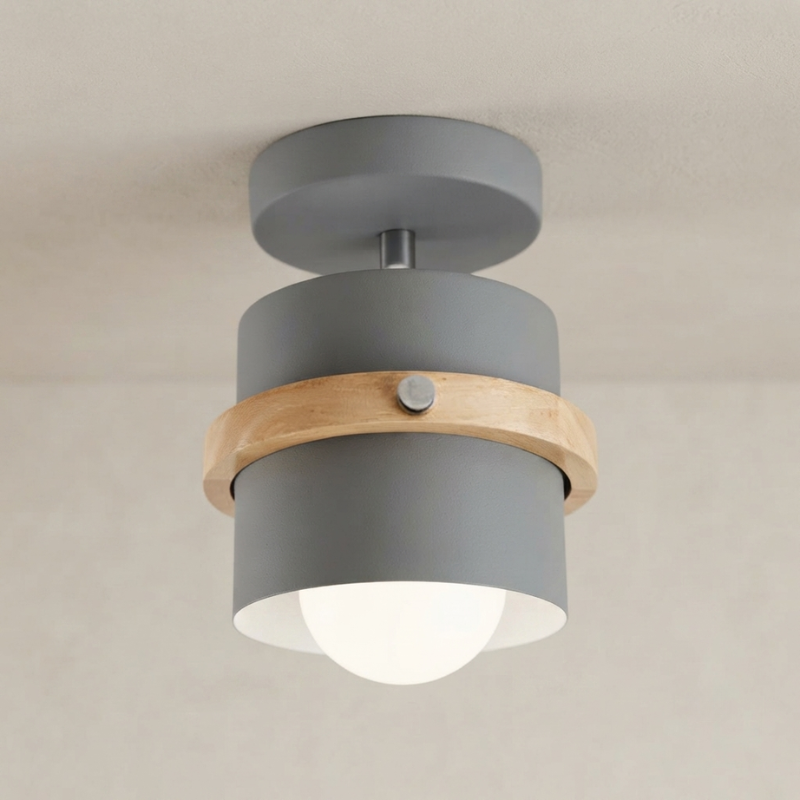 Ceiling light fixture with gray finish and wooden band on a neutral background