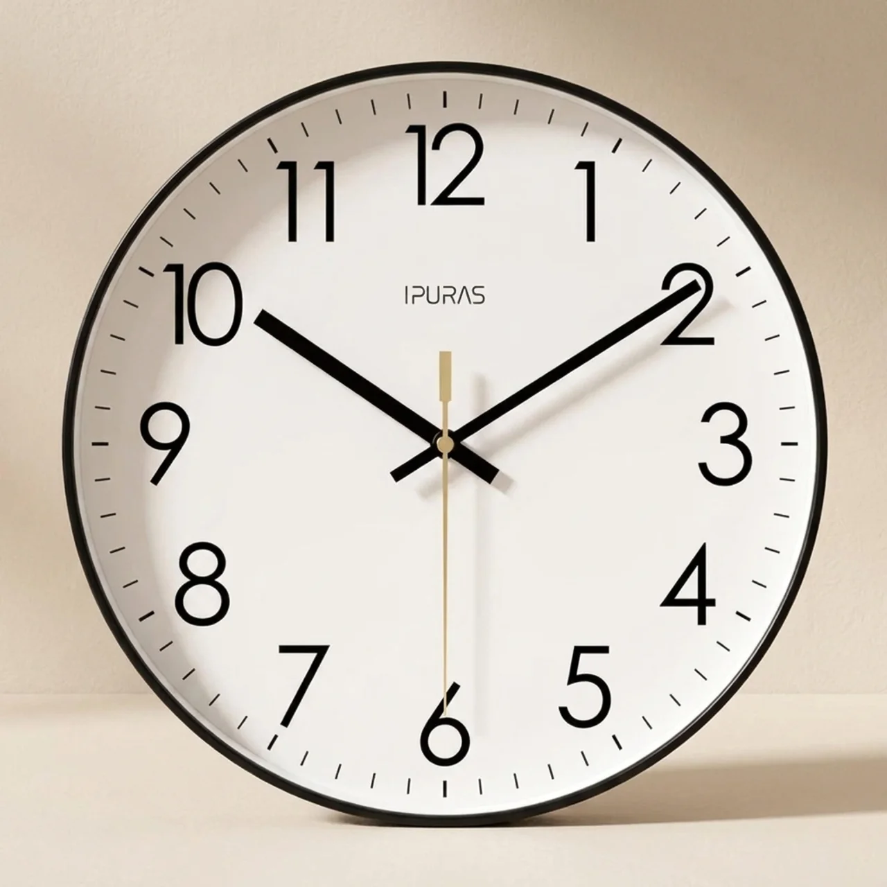 Round wall clock with black frame and white face on a beige background