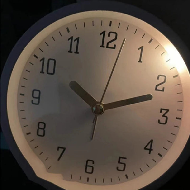 Wall clock with soft-light night light feature on a dark background