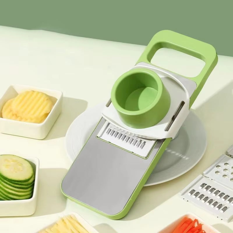 Green and white vegetable chopper with sliced vegetables on a light background