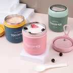 Set of four insulated food containers with colorful lids on a light pink surface.