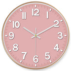 Round wall clock with a pink face and gold frame on a white background