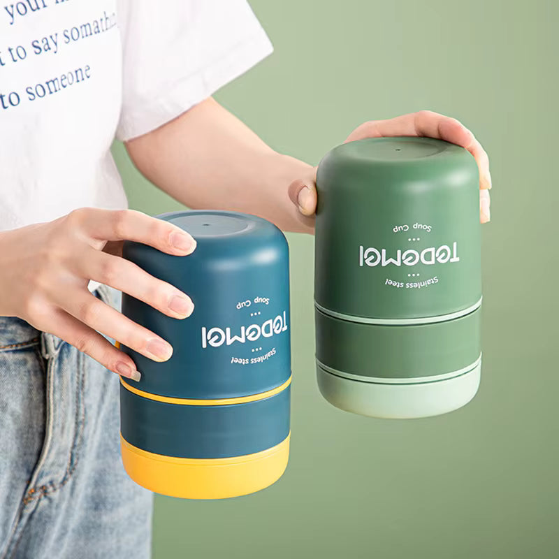 Two cylindrical containers, one blue and yellow, the other green, held by a person against a green background.