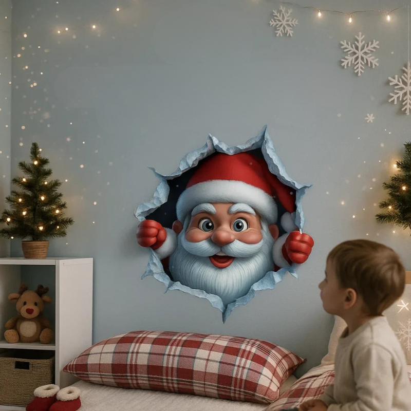 A child sits beside a bed in a decorated bedroom, looking at a large wall decal showing Santa Claus peeking through a torn hole. The room has a light blue wall with string lights, white snowflake decorations, a small Christmas tree, and red-and-white plaid bedding.