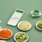Green vegetable chopper with sliced vegetables on a green background