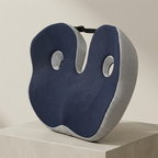 Blue and gray neck pillow on a beige background