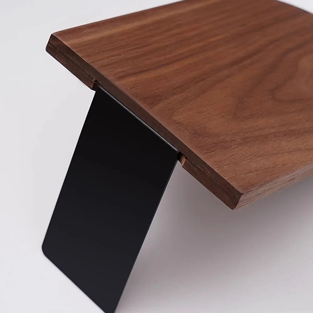 Wooden table with a black metal leg on a white background