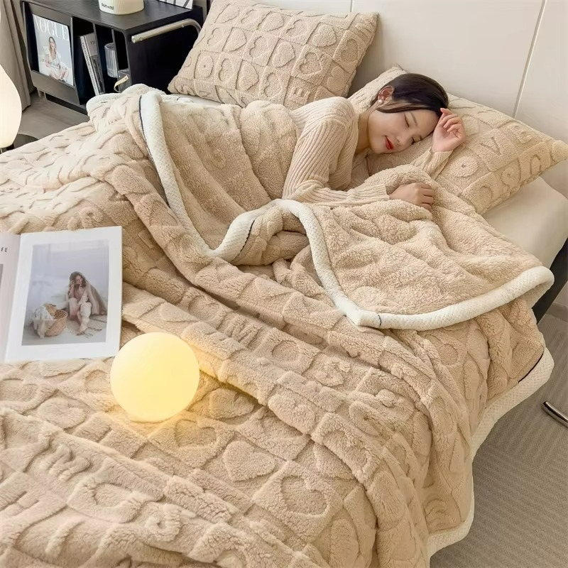 Woman lying on a bed under a beige textured blanket with a lamp nearby.